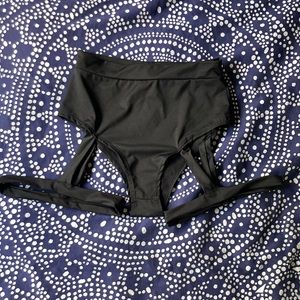 Black bootie shorts with attached garters.